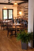 a dining room with wooden tables and chairs at Bonnie View Inn in Haliburton