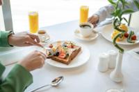 a group of people sitting at a table with a plate of food at JW Marriott Marquis City Center Doha in Doha