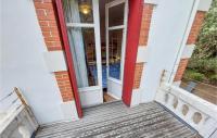 a red door on a building with a wooden stairs at Stunning Home In Saint-palais-sur-mer With Wifi And 6 Bedrooms in Saint-Palais-sur-Mer
