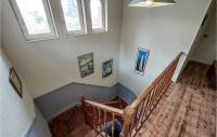 a set of stairs in a house with windows at Stunning Home In Saint-palais-sur-mer With Wifi And 6 Bedrooms in Saint-Palais-sur-Mer