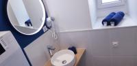 a small bathroom with a mirror and a sink at Escapade Niortaise - Studios climatisés hyper-centre de Niort in Niort