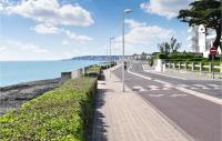 a road next to the ocean with a street light at Stunning Home In Saint-palais-sur-mer With Wifi And 6 Bedrooms in Saint-Palais-sur-Mer