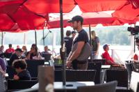 a man is standing under a red umbrella at Bonnie View Inn in Haliburton