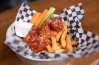 a basket of food with meat and french fries and vegetables at Bonnie View Inn in Haliburton