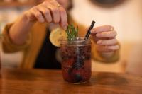 a person is putting a drink in a cup at Bonnie View Inn in Haliburton