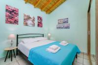 A bed or beds in a room at Georgios House