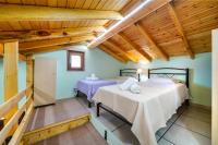 A bed or beds in a room at Georgios House