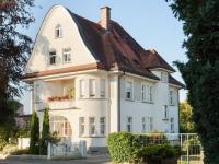 a white house with a gambrel roof at Hotel Schöngarten garni in Lindau