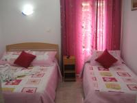 A bed or beds in a room at Hostal Huespedes Toledo