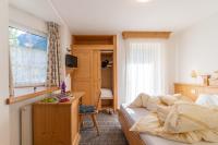 A bed or beds in a room at Albergo Canazei
