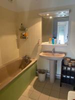 a bathroom with a sink and a bath tub at Grand appartement F3 - Centre- ville Le Bourget in Le Bourget