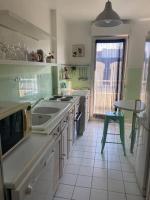 a kitchen with a sink and a table in it at Grand appartement F3 - Centre- ville Le Bourget in Le Bourget