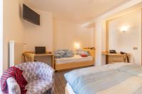 A bed or beds in a room at Albergo Canazei