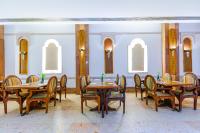 a dining room with wooden tables and chairs at The Grand Hotel, Hurghada in Hurghada