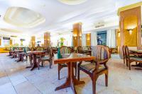 a dining room with wooden tables and chairs at The Grand Hotel, Hurghada in Hurghada