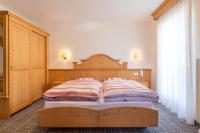 A bed or beds in a room at Albergo Canazei
