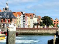 a group of buildings on the side of a river at Rijksmonument Havenzicht, met zeezicht, ligging direct aan zee en centrum in Vlissingen