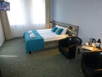 Łóżko lub łóżka w pokoju w obiekcie Hotel Giżycko
