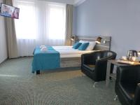Łóżko lub łóżka w pokoju w obiekcie Hotel Giżycko