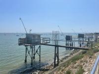 a pier in the water next to a beach at Studio cosy avec terrasse, proche Chantiers et Airbus in Saint-Nazaire