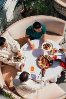 a group of people sitting around a table eating food at W Hollywood in Los Angeles