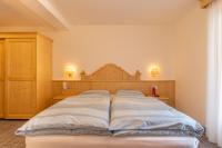 A bed or beds in a room at Albergo Canazei