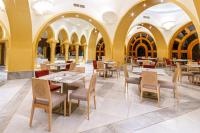 a restaurant with tables and chairs and arched ceilings at The Grand Resort in Hurghada