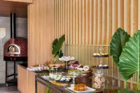 a buffet with a bunch of food on a table at Ramada Encore by Wyndham Indore Nipania in Indore