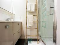 a bathroom with a towel ladder next to a shower at SACHA centre-ville Narbonne in Narbonne