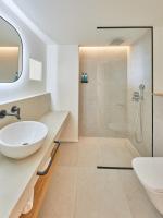 a bathroom with a white sink and a shower at Hotel & Spa Blau Parc in San Antonio