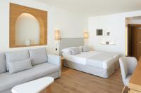 a hotel room with a bed and a couch at Hotel & Spa Blau Parc in San Antonio