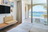 a bedroom with a view of the ocean at Hotel & Spa Blau Parc in San Antonio
