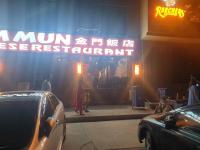 a sign on the side of a building with cars parked in front at SPACE Luxury Rental Suites in Rawalpindi