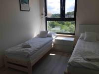 Posteľ alebo postele v izbe v ubytovaní Apartament Kraków Arena