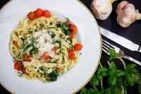 a plate of pasta with tomatoes and other vegetables at Hotel Kompleks Beskid z basenem i stokiem narciarskim - blisko Babiej Góry in Spytkowice