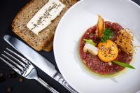 a plate of food with a tomato sauce and bread at Hotel Kompleks Beskid z basenem i stokiem narciarskim - blisko Babiej Góry in Spytkowice