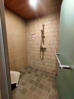 a bathroom with a shower and a toilet at Beitou Hot Spring Resort in Taipei