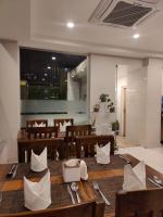 a dining room with a table and wooden chairs at Hotel Krishna Kathmandu in Kathmandu