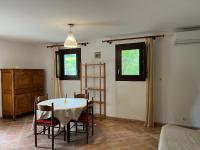 a dining room with a table and chairs at Corte Appartement T2 en résidence privée in Corte