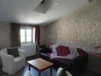 a living room with a couch and a chair at Les chambres de Blanot in Blanot