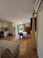 a bedroom with a bed and a kitchen with a table at Corte Appartement T2 en résidence privée in Corte