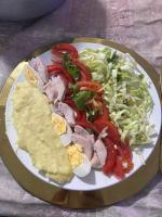 a plate of food with meat and vegetables on a table at Main Stream Beach Villa in Senga