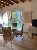 a dining room with a glass table and chairs at Le Clos des Grands Frênes in Pons