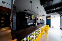 a bar in a restaurant with yellow chairs at The Villa & Barrel Lounge in Shizuoka