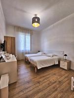 A bed or beds in a room at La Ca' Bianca Affittaly Apartments