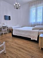 A bed or beds in a room at La Ca' Bianca Affittaly Apartments