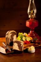 un tagliere con una pagnotta di pane e verdure di Bohemian Breeze a Bald Knob