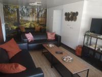 a living room with a couch and a coffee table at Gîte Les trois charmes in Gouvy