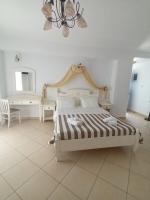 a bedroom with a bed and a chandelier at Theofanis Studios in Agia Anna Naxos
