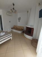 a living room with a couch and a fireplace at Theofanis Studios in Agia Anna Naxos